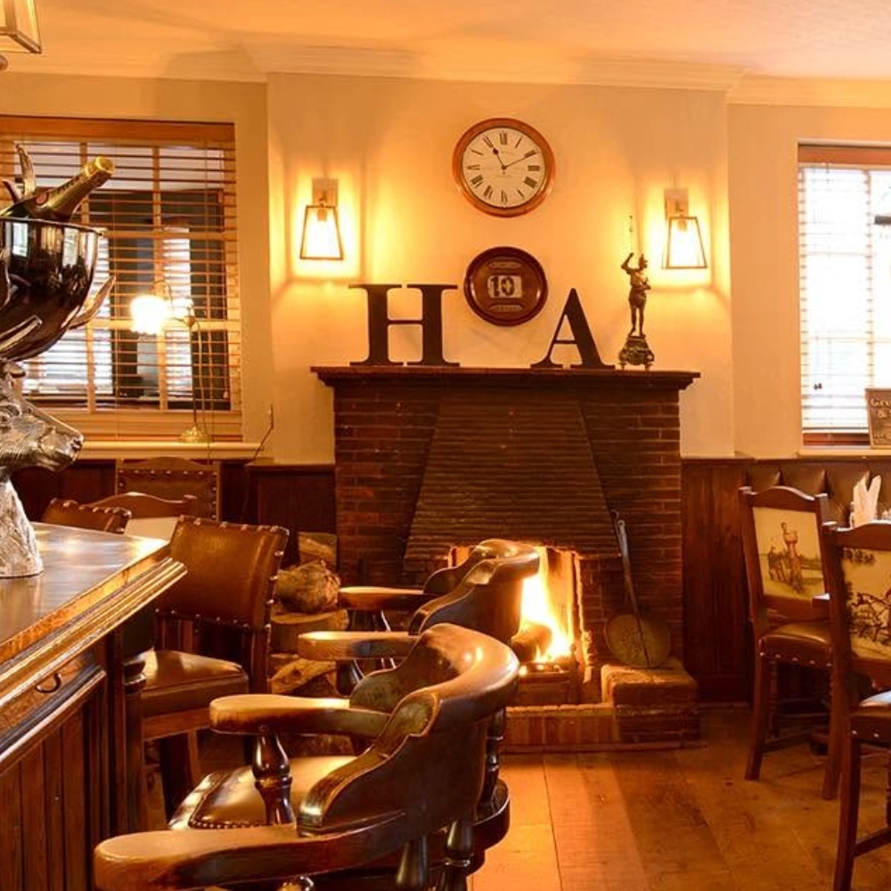 Traditional fireplace and seating area inside The Hare Arms