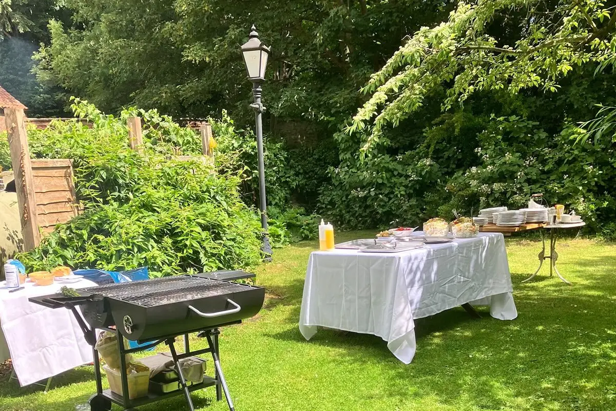 Outdoor buffet and barbecue set up in the gardens at The Hare Arms