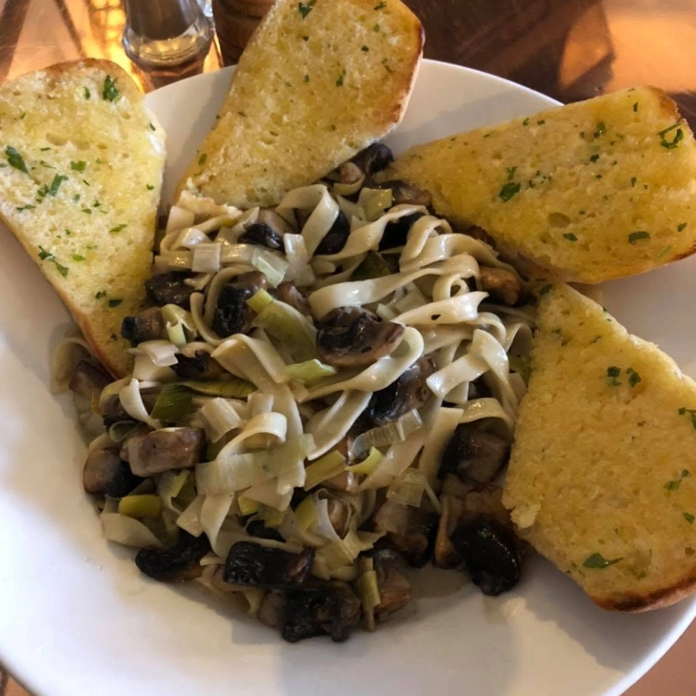 Creamy mushroom tagliatelle served with garlic bread at The Hare Arms Title: Mushroom Tagliatelle at The Hare Arms