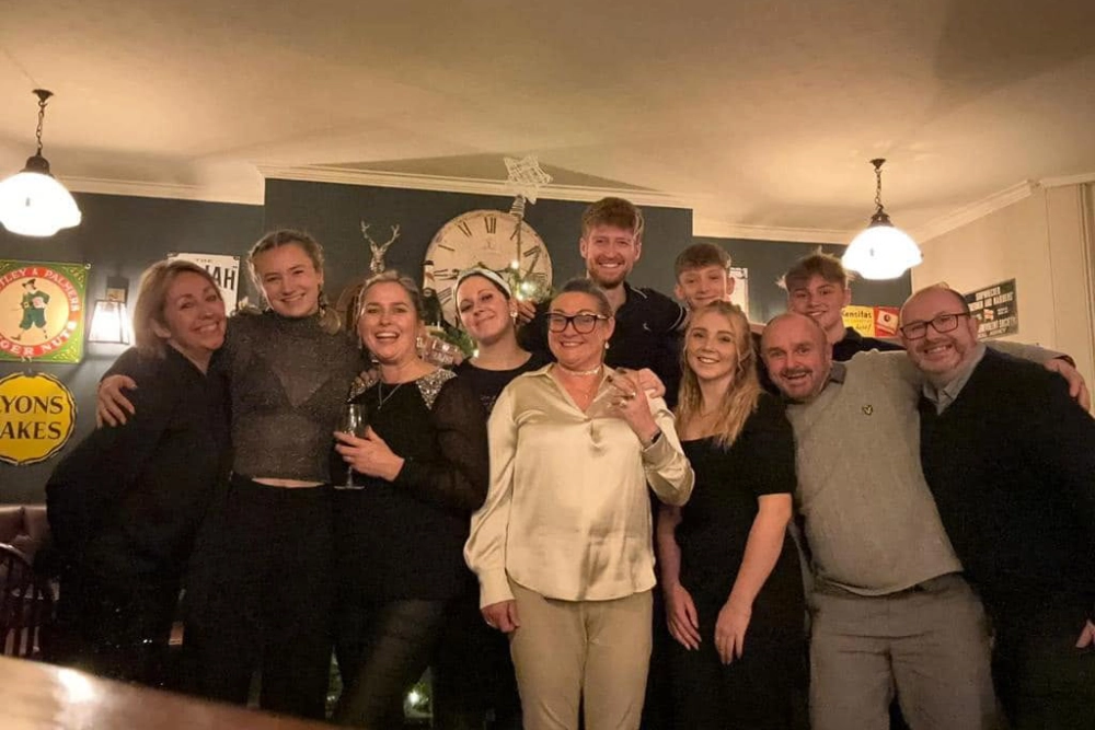 Group of staff and guests gathered inside The Hare Arms