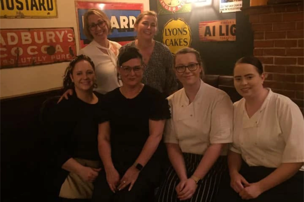 The Hare Arms team standing together inside the pub
