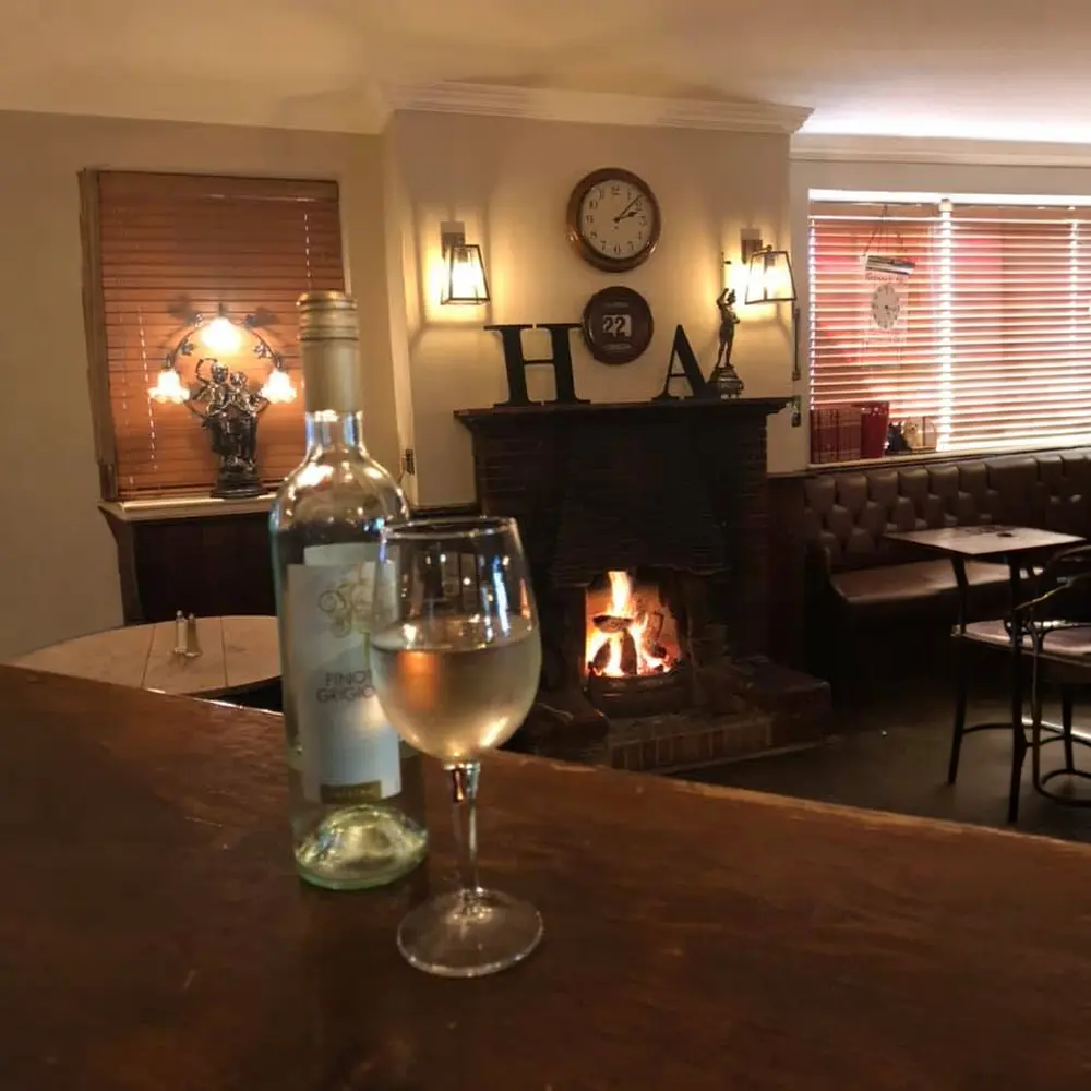 A glass of white wine enjoyed beside the open fire at The Hare Arms.