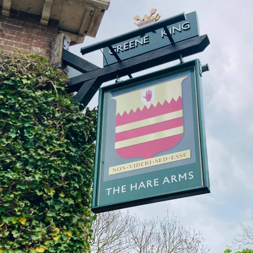 The Hare Arms Greene King pub sign outside the building