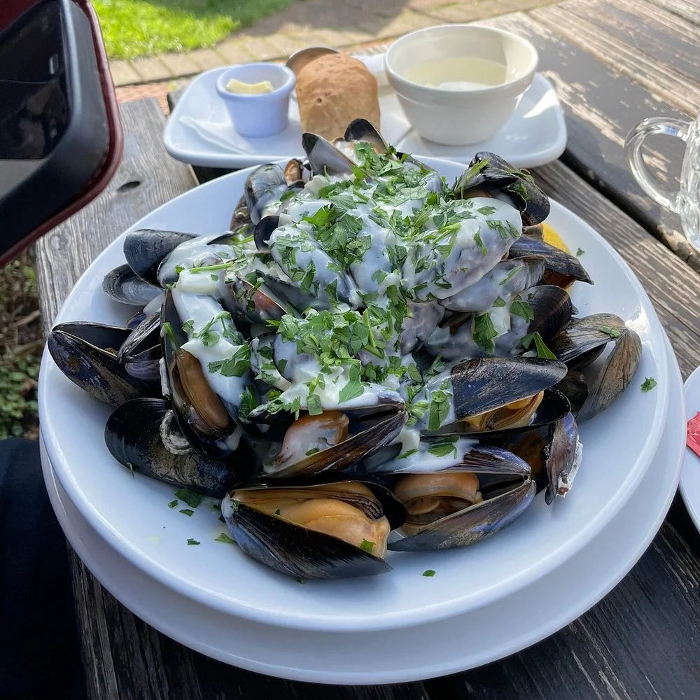Mussels served in a creamy sauce and finished with fresh parsley.