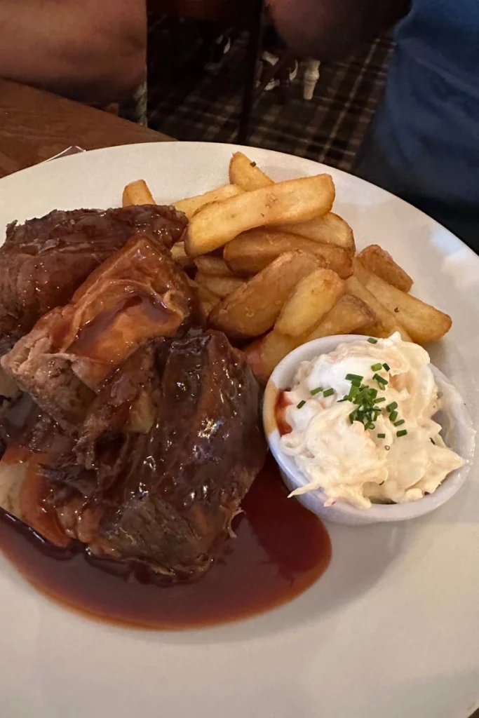 Meat in rich gravy served with chunky chips and coleslaw